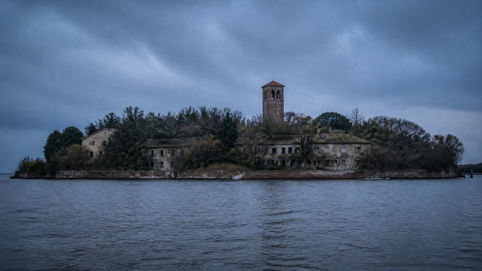 Poveglia Island abandoned buildings and bell tower across the Venetian Lagoon