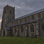Black Shuck story inspired Suffolk flint church under a dark autumn sky
