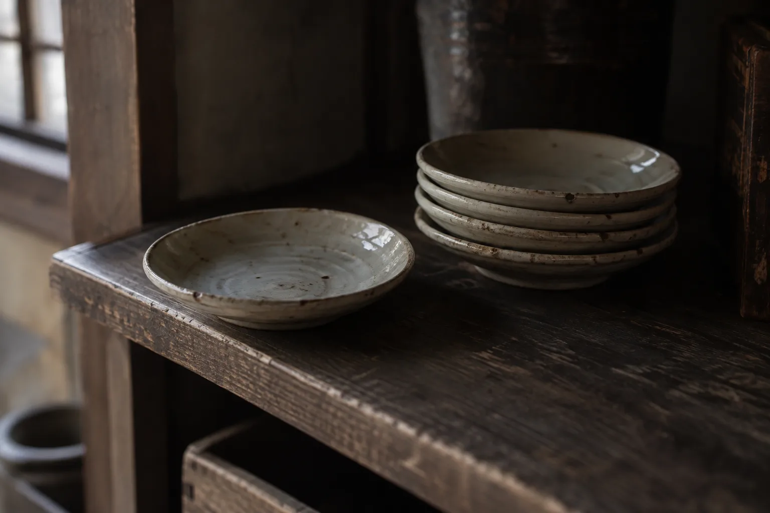 Okiku's Well legend represented by ceramic plates in a dark wooden room